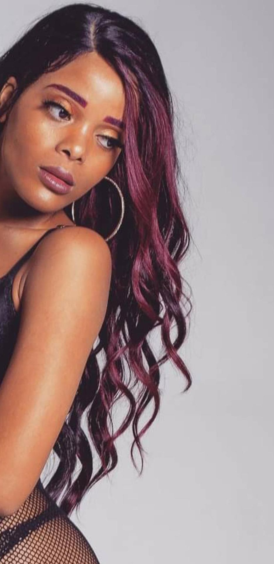 Profile portrait of AlxZandria with burgundy waves