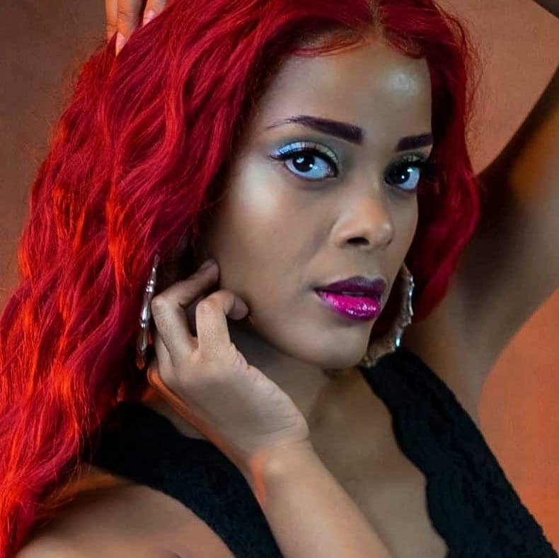 AlxZandria close-up headshot with vivid red hair